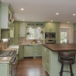 Painted kitchen cabinets in a mint green color.