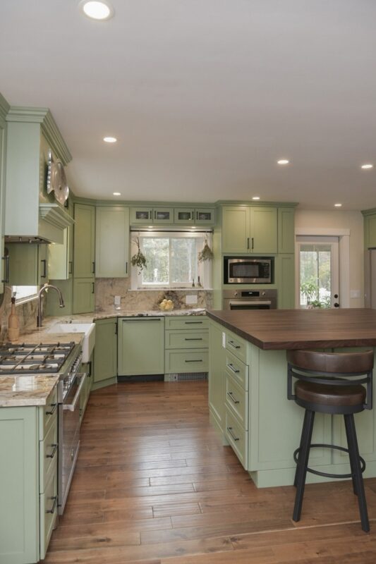 Painted kitchen cabinets in a mint green color.
