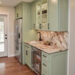 Painted kitchen cabinets in a mint green color.