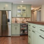Painted kitchen cabinets in a mint green color.