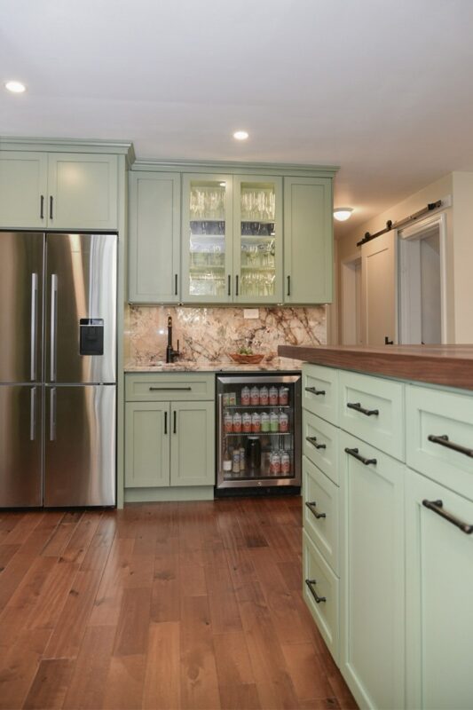 Painted kitchen cabinets in a mint green color.