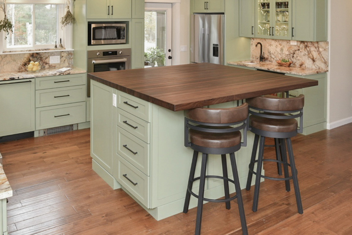 Painted kitchen cabinets in a mint green color. Shows island with stools.
