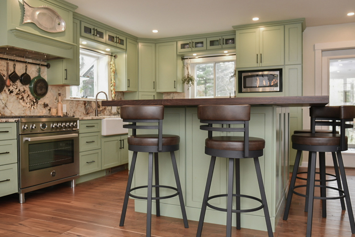 Painted kitchen cabinets in a mint green color. Shows island with stools.
