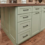 Painted kitchen cabinets in a mint green color.