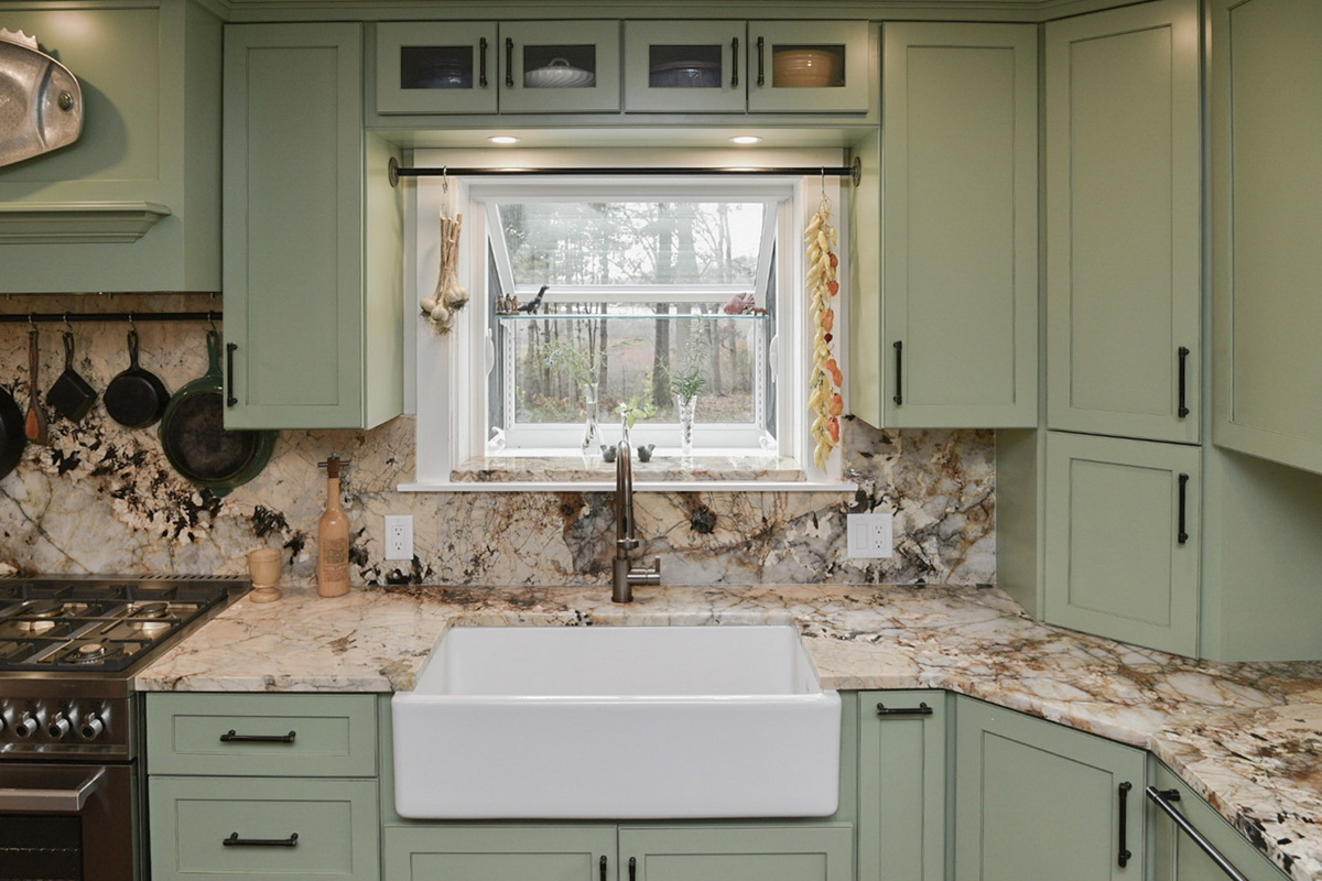 Painted kitchen cabinets in a mint green color. View of window over sink.