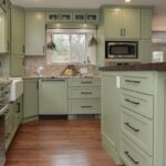 Painted kitchen cabinets in a mint green color.