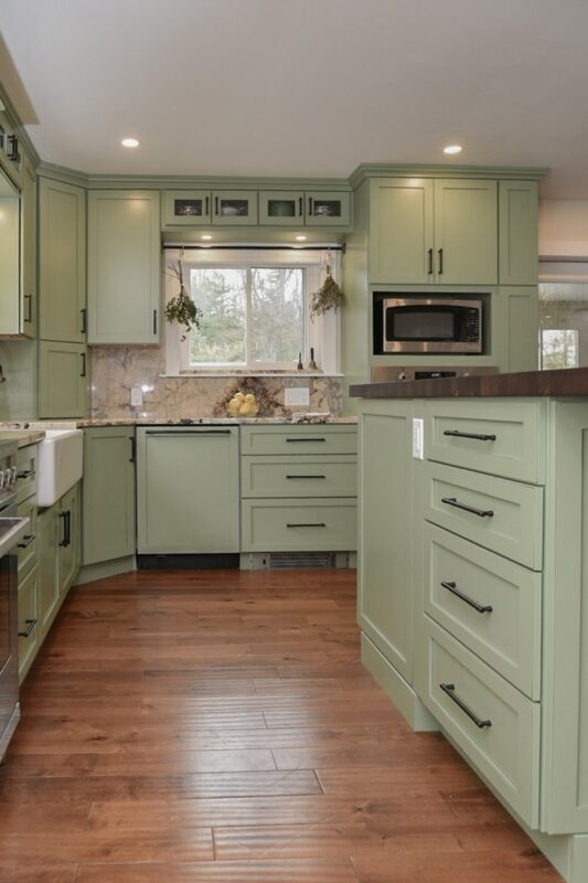 Painted kitchen cabinets in a mint green color.