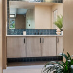 Retro bathroom with slab door floating vanity finished with the earthy Montana stain on Maple.