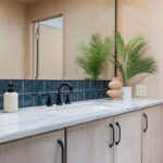 Retro bathroom with slab door floating vanity finished with the earthy Montana stain on Maple.