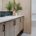 Retro bathroom with slab door floating vanity finished with the earthy Montana stain on Maple.