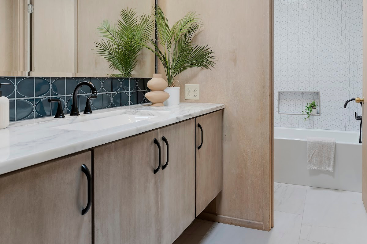 Retro bathroom with slab door floating vanity finished with the earthy Montana stain on Maple.