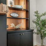 Open shelf bookcase next to a fireplace