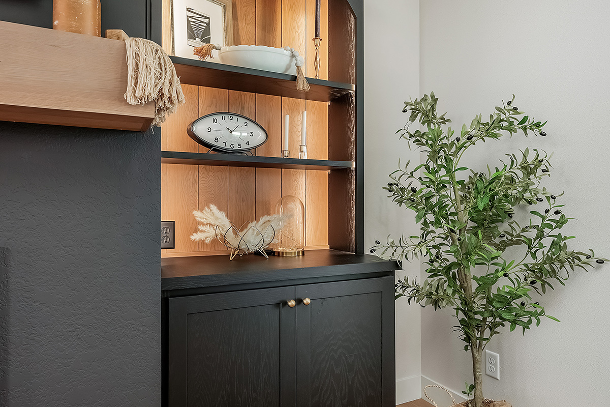 Open shelf bookcase next to a fireplace