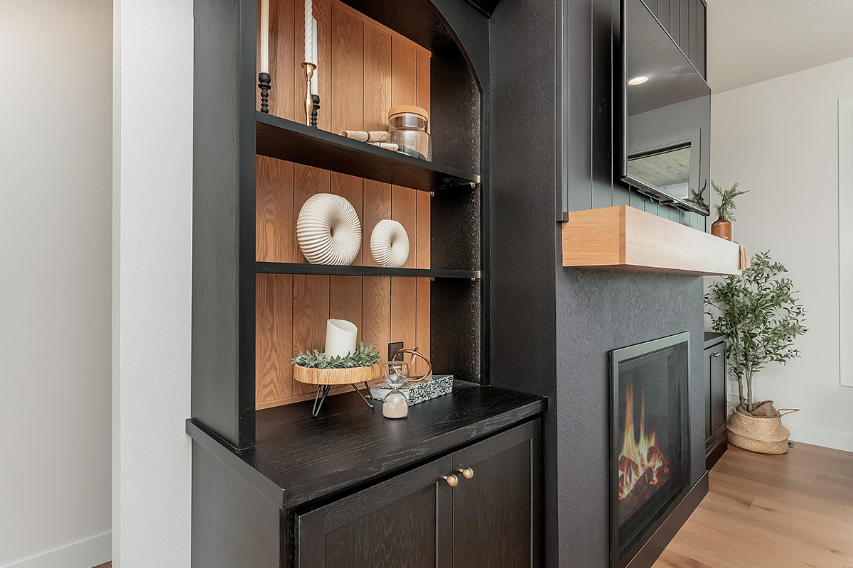 Open shelf bookcase next to a fireplace