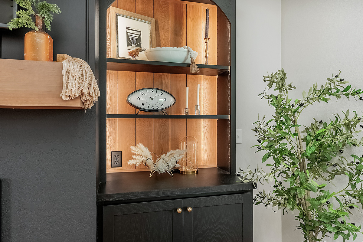 Open shelf bookcase next to a fireplace