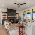 Living room showing couch seating and a fireplace with bookcases on each side.