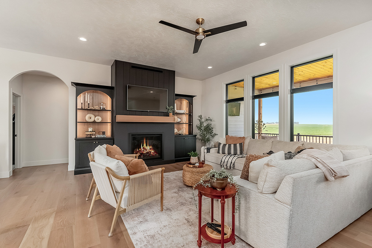Living room showing couch seating and a fireplace with bookcases on each side.