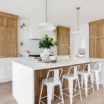White painted kitchen cabinets with natural wood accent cabinets