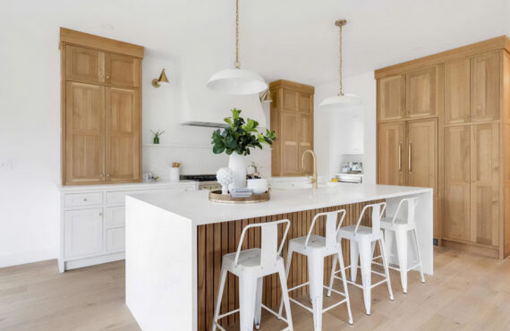 White painted kitchen cabinets with natural wood accent cabinets