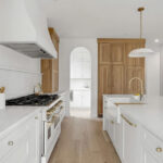 White painted kitchen cabinets with natural wood accent cabinets