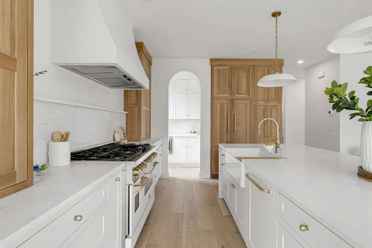 White painted kitchen cabinets with natural wood accent cabinets
