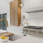 White painted kitchen cabinets with natural wood accent cabinets