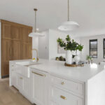 White painted kitchen cabinets with natural wood accent cabinets