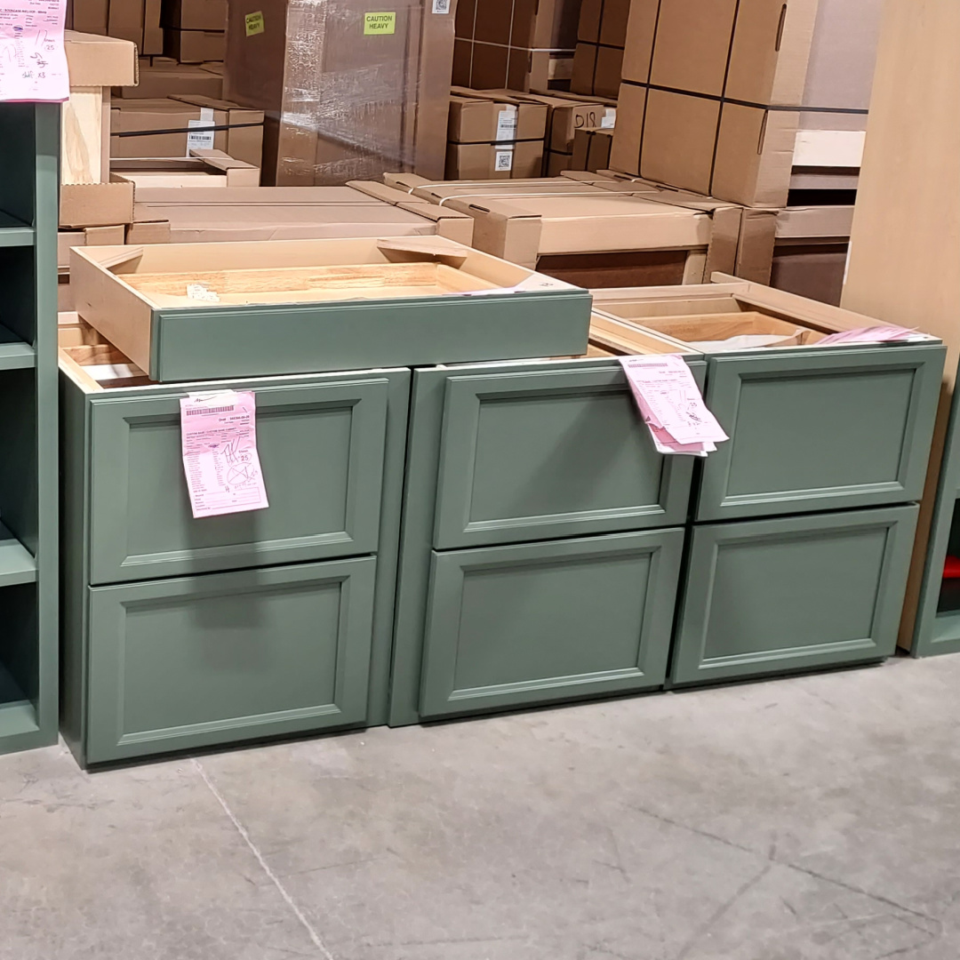 Green painted two drawer bases in a warehouse setting
