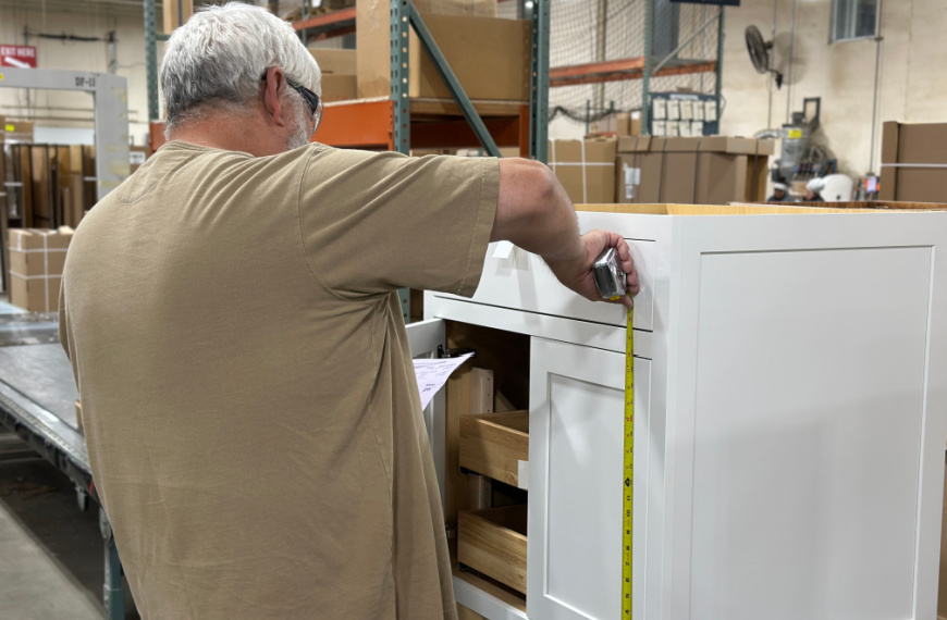 Man measuring a cabinet door