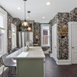 Painted green kitchen cabinets with unique wallpaper