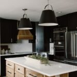 Black painted kitchen cabinets with light brown stained hood and island