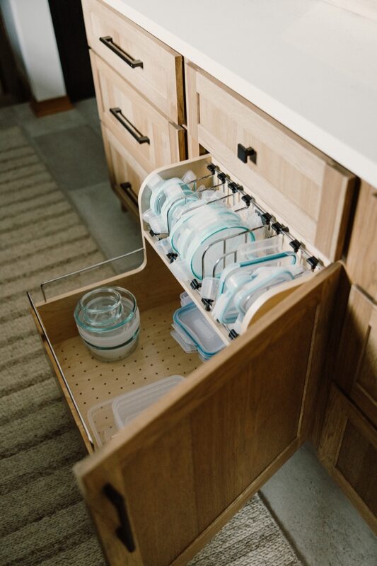 Food storage container organization accessory in a base cabinet.