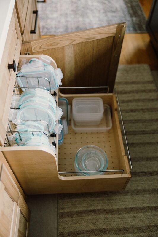 Food storage container organization accessory in a base cabinet.