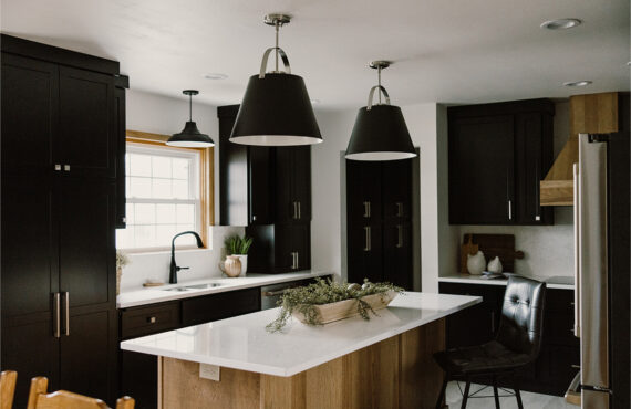 Black painted kitchen cabinets with light brown stained hood and island
