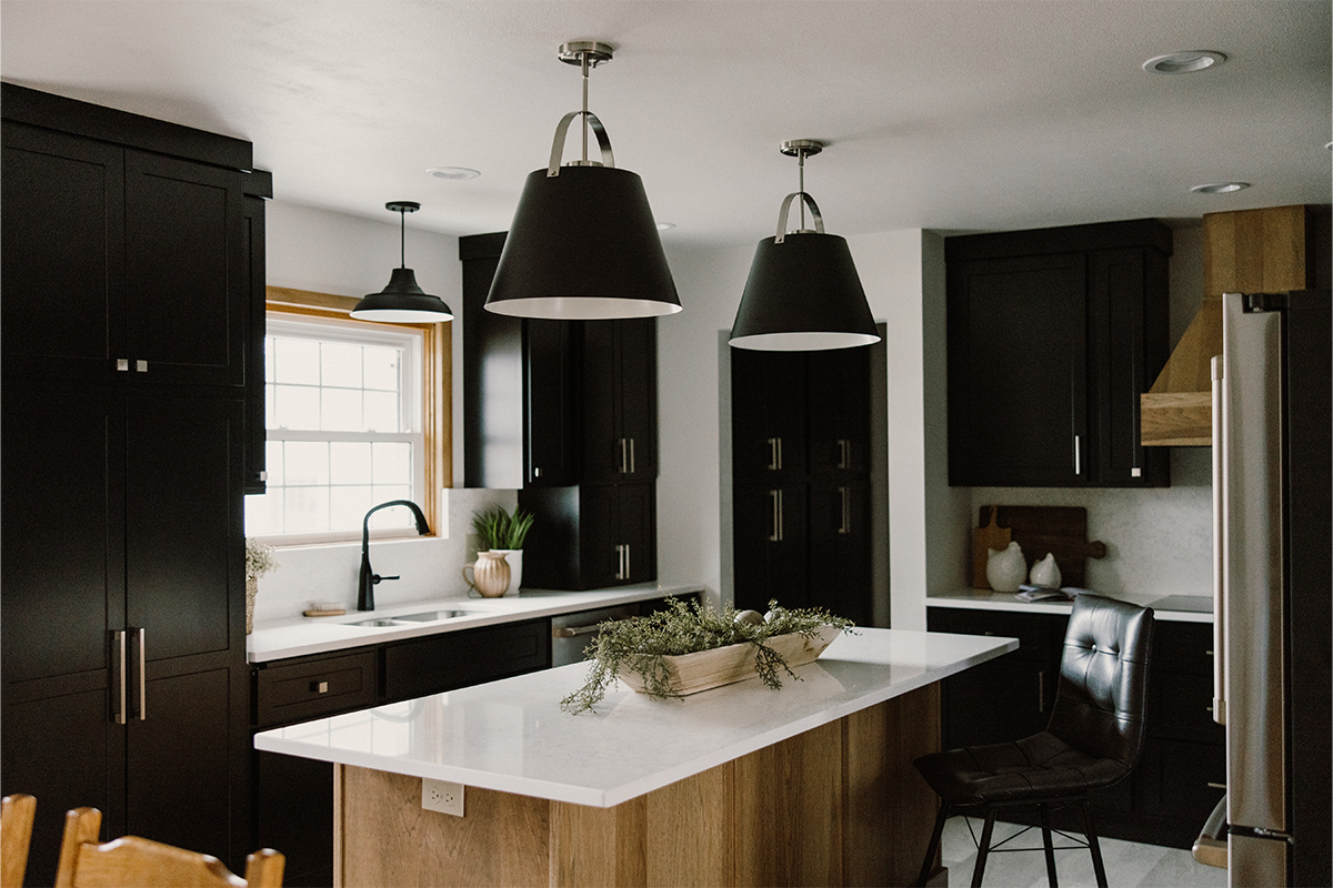 Black painted kitchen cabinets with light brown stained hood and island