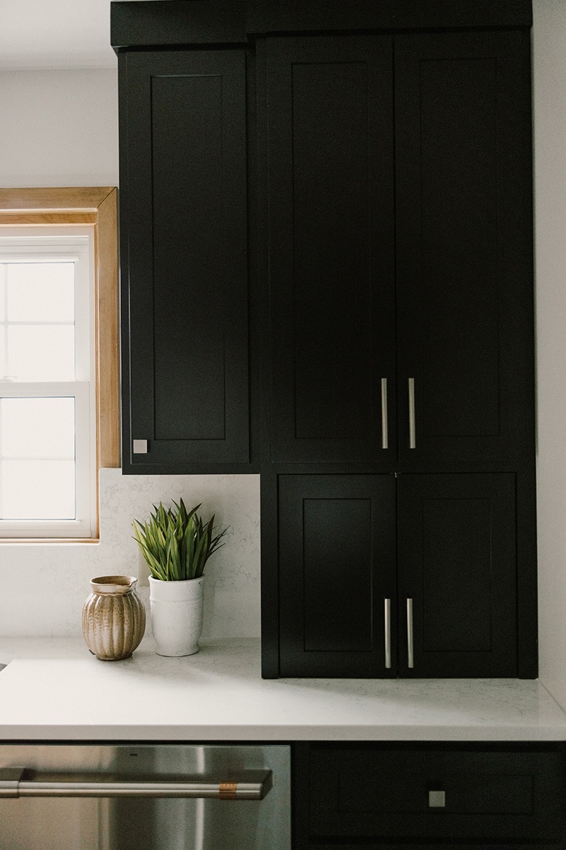 Black painted kitchen cabinets.