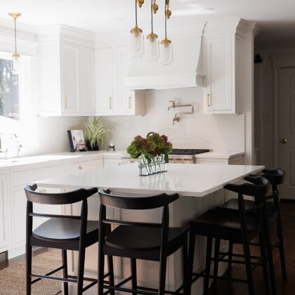 White kitchen with black island seating.