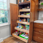 Tall utility cabinet with open doors showing roll trays