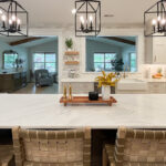Painted white kitchen perimeter cabinets with brown stained island.