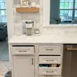Coffee area in a kitchen with stained floating shelves