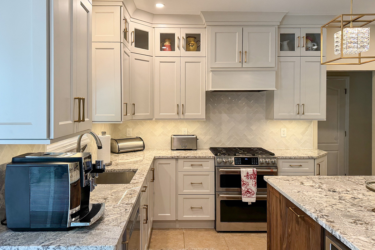 White painted kitchen perimeter cabinets and walnut natural island.
