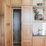 Walk-in pantry cabinet door open looking inside the pantry.