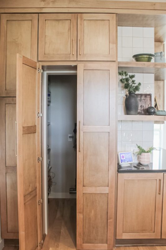 Walk-in pantry cabinet door open looking inside the pantry.