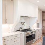 White painted cabinets and hood above stove