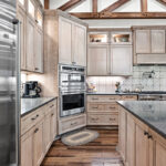 Light stained kitchen cabinets with exposed beams