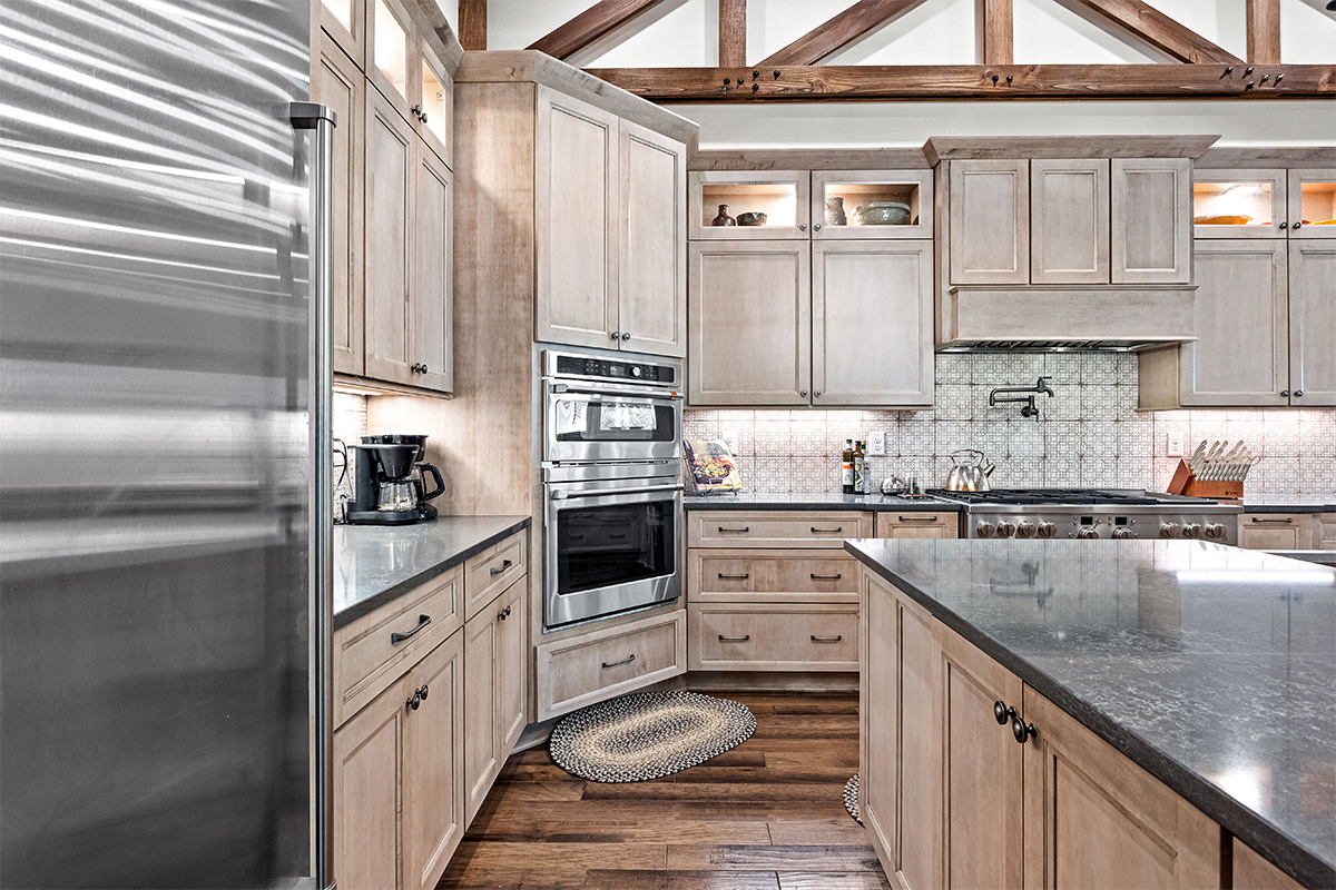 Light stained kitchen cabinets with exposed beams