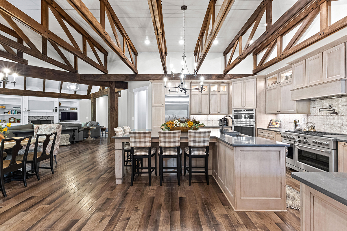 Light stained kitchen cabinets with exposed beams
