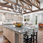 Light stained kitchen cabinets with exposed beams