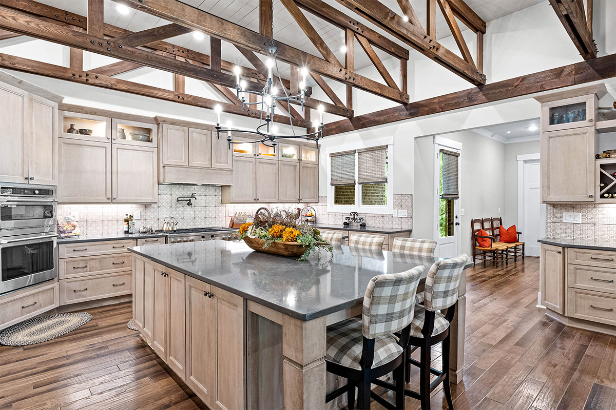Light stained kitchen cabinets with exposed beams