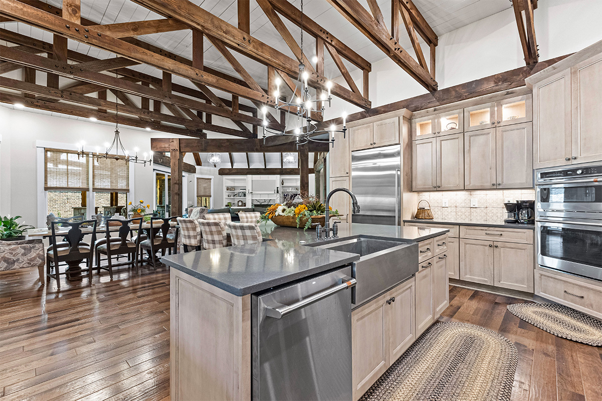 Light stained kitchen cabinets with exposed beams